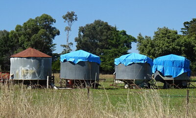 Round field bins with octagonal tarp covers